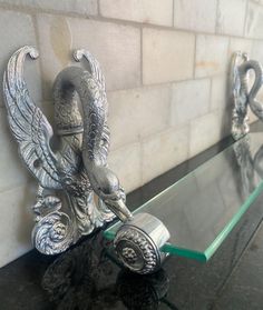 an elephant statue sitting on top of a glass shelf