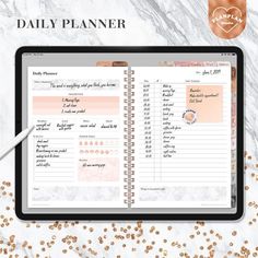 the daily planner is open on top of a tablet with gold confetti around it