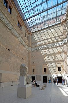 the inside of a building with people walking around