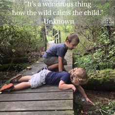 two young boys laying on a wooden bridge in the woods with a quote above them