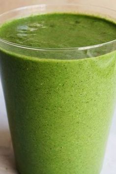 a green smoothie in a glass on a table