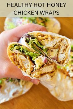 a hand holding a chicken wrap with lettuce and other ingredients in the background text reads healthy hot honey chicken wraps