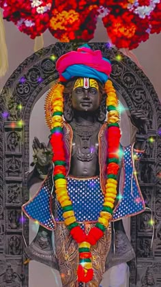 the statue is decorated with flowers and garlands