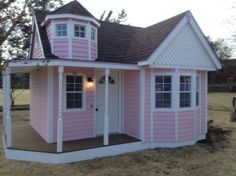 a pink house with white trim and windows