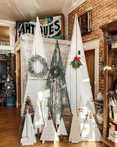 three wooden christmas trees sitting on top of a hard wood floor