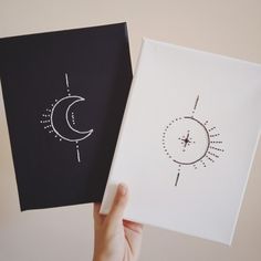 two handmade greeting cards with sun and moon designs on them, one is black and the other is white