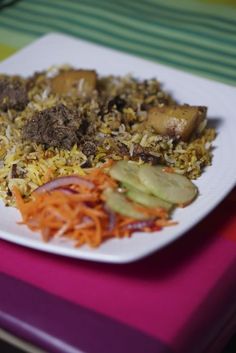 a white plate topped with lots of food on top of a pink and purple table