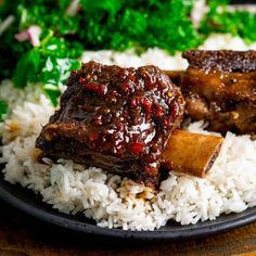 some meat and rice on a plate with broccoli