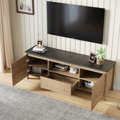 a flat screen tv mounted to the side of a wooden entertainment center in a living room