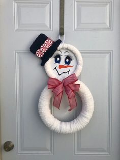 a snowman wreath hanging on the front door