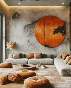 a living room filled with lots of furniture next to a large painting on the wall