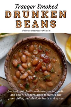 a wooden bowl filled with beans next to other foods