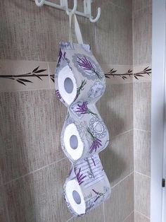 two rolls of toilet paper hanging on a wall