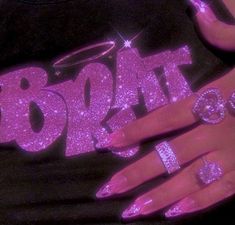 a woman's hand with pink glitter on it and two rings around her finger