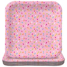 a pink paper plate with sprinkles on it