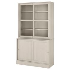 a white cabinet with glass doors on the top and bottom shelves, in front of a white background