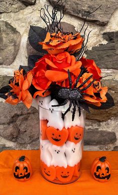 a vase filled with halloween decorations on top of a table