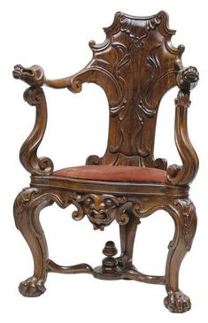 an ornate wooden chair with red upholstered seat and arm rests against a white background