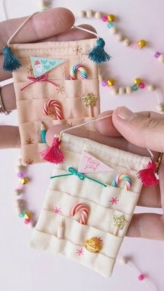 two handmade candy bags with tassels on them