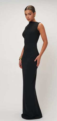 The Verona gown is so evocative of 90s glam. Made from a luxurious stretch-crepe with a defining high neckline and a simplistic silhouette. This is the ultimate gown to hire for a formal function, event night or black tie wedding. style with with a clutch and your good to go. Please not this is not a bra friendly dress. Minimalist Gown Classy, Elegant Black Long Dress, Black Cocktail Dress Long, Simple Elegant Long Dress, Long Sleeve Holiday Party Dress, Classy Formal Dresses Long, Modern Party Dress, Sleek Formal Dress, Formal Evening Dresses Simple