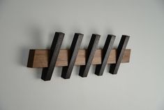 four wooden hooks mounted on the wall