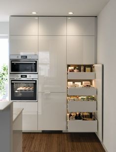 a kitchen with white cabinets and an oven