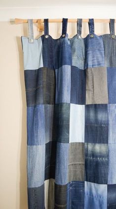 a blue and gray checkered curtain hanging from a wooden rod