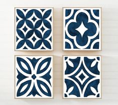 four blue and white tile designs on a wall