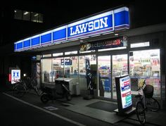 a store front at night with bikes parked outside