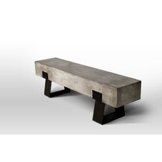 a concrete bench sitting on top of a white floor