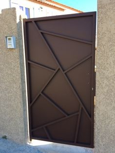 a brown door with an intricate design on it's side wall in front of a building