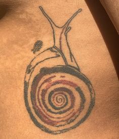 a person with a tattoo on their stomach has a spiral design in the shape of a man's torso