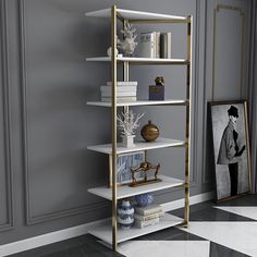 a white and gold shelving unit with pictures on the wall next to it in a room