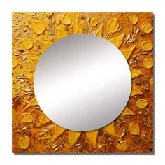 a round mirror sitting on top of a wooden table next to a yellow flowered wall