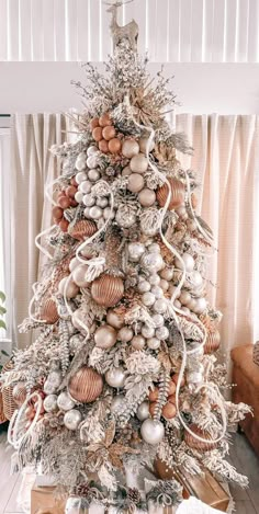 a white christmas tree with ornaments on it