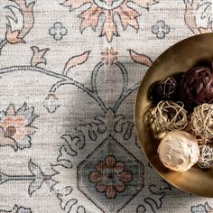 a bowl filled with lots of different types of food on top of a table next to a rug