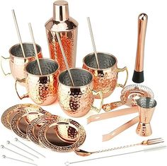 a set of copper colored cocktailware including cups and utensils