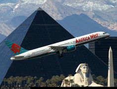 an american west jet flying over the pyramids in las vegas, nv with mountains in the background