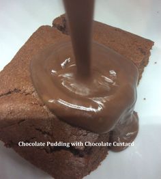 chocolate pudding with chocolate custard being poured onto it on top of a piece of brownie