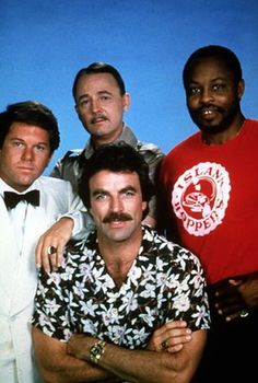 three men posing for the camera with one man wearing a shirt and bow tie in front of them