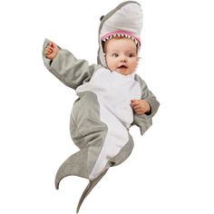 a baby in a shark costume is flying through the air