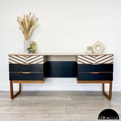 two black and white dressers sitting next to each other