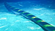 an inflatable tube floating on top of a swimming pool with blue water and bubbles