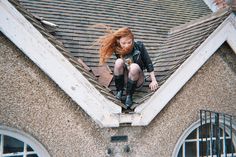 a woman sitting on top of a roof