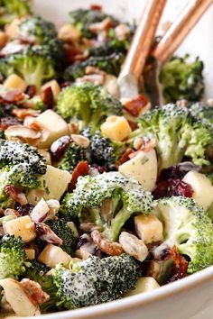 broccoli and cranberry salad in a white bowl with chopsticks