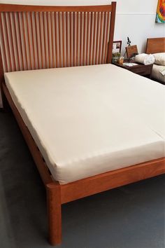 a bed with wooden headboard and foot board