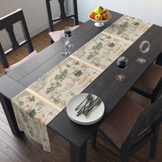 a dining table set with place settings and fruit on the plate in front of it