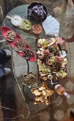 a glass table topped with different types of food on top of it's sides