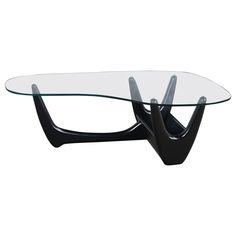 a glass table with black legs and an unusual design