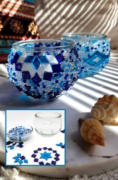 blue and white glass bowls with seashells in them on a table next to other items